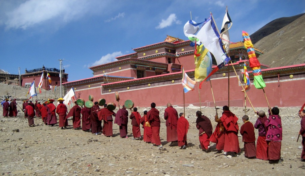 Monks circumambulate the shedra complex in 2014